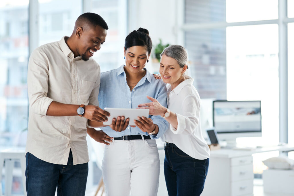 group of businesspeople using a digital tablet together in an office